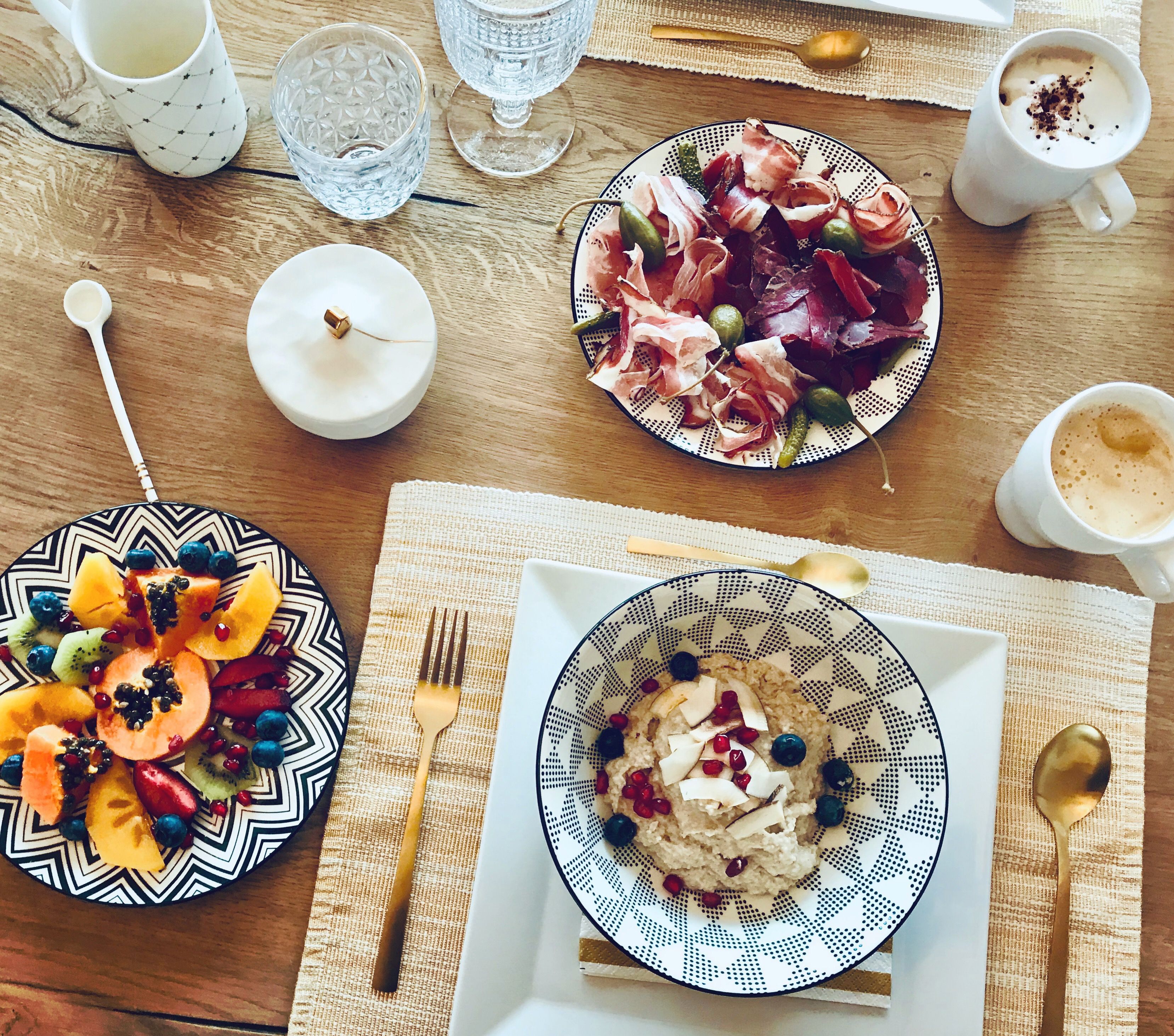 Breakfast table for two with fruit, granola and coffee