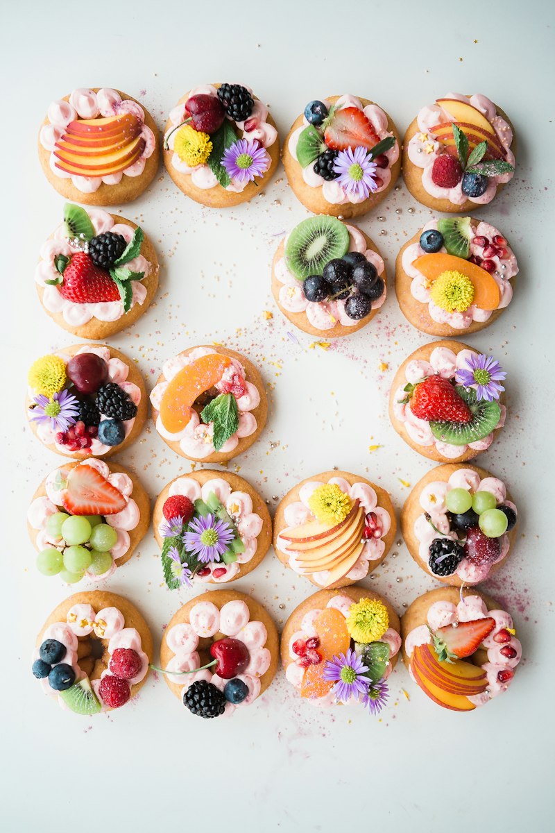 Rows of small fruit tartlets with fresh berries