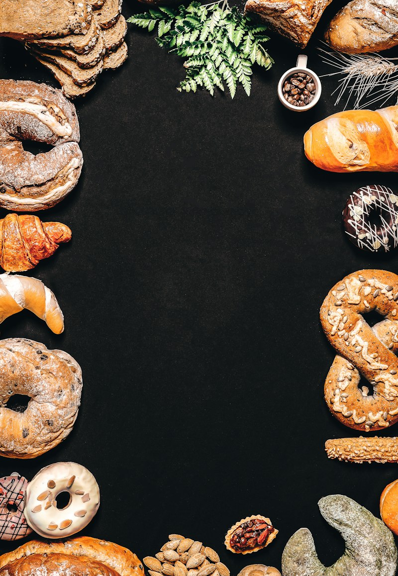 Assorted doughnuts and pastries on a dark table